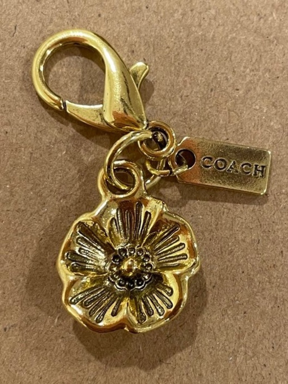 Coach Gold Tone Floral Charm with Logo Tag